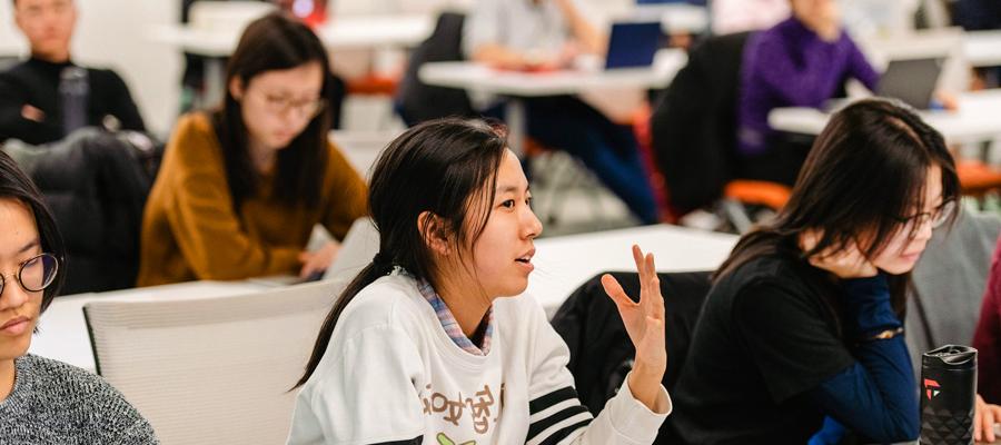 Female student engaging in discussion in class