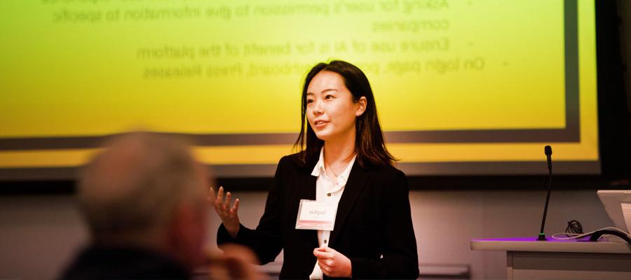 Female student presenting in front of a class